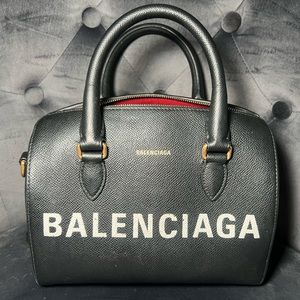 Authentic. Removable strap. Black pen marks inside can be cleaned